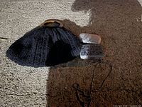Photo showing all three handbags: large black embroidered handbag with wooden handles, small silver glitter clutch, and small black beaded handbag with strap.