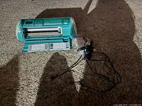 Electric circuit board printer device with fold-out keyboard panels and power adapter.