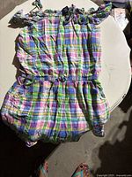 Tommy Hilfiger romper laid flat on a white table showing full front view.