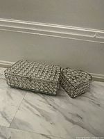 Two rhinestone jewelry boxes, rectangular and heart-shaped, placed side by side.