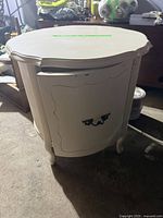 White vintage drum style nightstand, front view showing door and curved legs