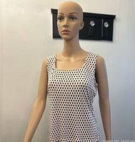 Front view of the sleeveless top displayed on mannequin showing square neckline and diamond pattern.
