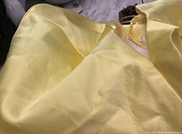 Close-up photo of the dress fabric showing small defects and folds