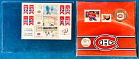 Photo shows two sealed packages: one blue containing the 2014 Montreal Canadiens 25-cent coins, and one red folder with lenticular 2009 NHL stamps featuring players and banners.