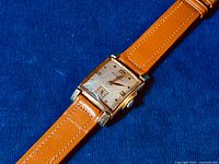 Front angled view of vintage Wittnauer tank watch showing dial and gold-filled case.