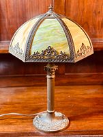 Unlit lamp front view showing six-panel slag glass shade and bronzed metal base.