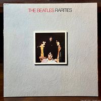 Front cover of The Beatles Rarities LP album showing textured white background and band photo centered on cover.
