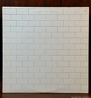 Front cover of gatefold LP showing the white brick wall design with slight wear marks