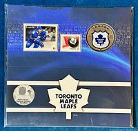 Front view of the full gift set showing the coin and two stamps inside original packaging with 'Toronto Maple Leafs' maple leaf logo.