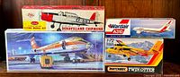 Four vintage airplane model kits: DeHavilland Chipmunk, Wardair A310, Matchbox Twin Otter, and another airplane kit with airport scene on box.