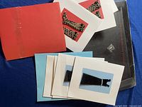 Set of postcards and colored envelopes arranged on flat surface