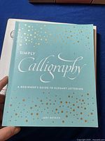 Front cover of the book 'Simply Calligraphy' by Judy Detrick, showing title and design.