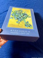 Decorative blue box with Van Gogh floral artwork and text: 'Van Gogh Flowers Still Life'.