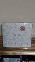 Packaged Calvin Klein king size sheet set in white with a faint pattern and 'KING' size sticker.