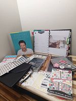 Overview photo showing Daytimer agenda binder, sticker sheets, tab dividers, and sticky notes arranged on a table.