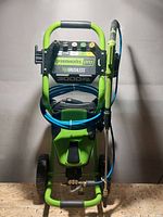 Front view of unit showing control panel, hose and spray gun