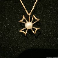 Close-up image of the 10K yellow gold pearl pendant and chain, showing the front view of the pendant centered on the chain.