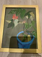 Front view of acrylic painting on canvas showing plant with green leaves and flowers in blue pot framed in gold-colored frame.