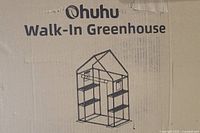 Box showing Ohuhu walk-in greenhouse branding and illustration of the greenhouse structure with shelves inside.