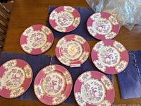 Overview of eight plates arranged on table with wrapped protective film