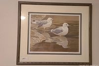 Framed print of two seagulls by Robert Bateman, signed, with water reflections, in rustic wood frame