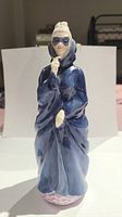 Front view of Royal Doulton Masque figurine showing blue cloak and mask