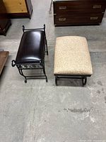 Top view of two stools side by side on concrete floor showing metal frames and cushioned seats, one beige fabric and one dark brown faux leather.