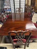 Full view of dining table with chairs arranged around it
