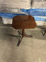 Overhead view of the octagonal tabletop and part of the pedestal base and legs beneath.