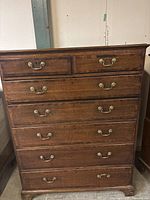 Front-facing view of chest showing all seven drawers and brass handles