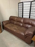 Three-quarter angle view showing full sofa, padded arms, back and seat cushions.