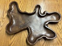 Top view of the natural wood bowl showing its irregular freeform shape and visible cracks.