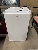 White Koolatron mini fridge with plain solid door, compact shape