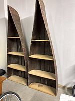 Two canoe-shaped curved shelving units side by side in storage area
