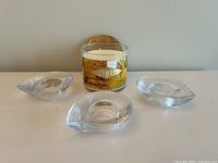 Set showing the Bath Body Works Leaves scented candle and three clear glass teardrop-shaped votive holders arranged on a surface.