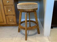 Front left three-quarter view showing oak frame, footrest and seat