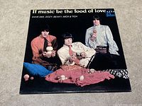 Front of album sleeve showing band members and album title.