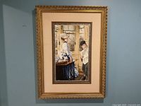 Frontal photo showing the full framed cross stitch artwork hung on a wall