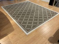 Full view of the large rectangular rug showing the repeating lattice pattern and border.