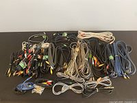 Top view showing a large assortment of bundled audio and video cables in various colors and connector types.