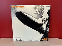 Front cover of the Led Zeppelin LP showing the iconic Hindenburg disaster image with the orange 'Led Zeppelin' text and Atlantic Records logo.