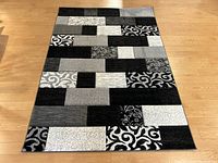 Full top-down view of the carpet showing the patchwork pattern, colors and condition.