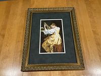 Full view of the framed cross stitch artwork showing the entire piece including the frame and matting