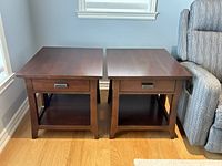 Pair of side tables side by side near window