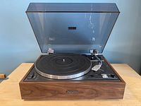 Front view of the Pioneer PL-15R turntable with dust cover open showing aluminum platter, tonearm and control panel with speed and start/stop switches.