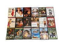Photo of all 18 DVD movies laid out flat showing front cover artwork including titles and key actors.