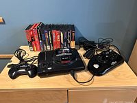 Overview showing console, two controllers, power adapters, RF cable and boxed games