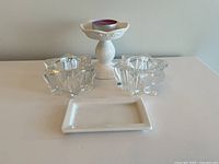 Wide angle photo showing all items: two crystal star candle holders, white ceramic pillar candle holder, and small rectangular ceramic plate.