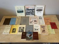 Photo showing the full collection of various antique Canadian historical books, pamphlets, and booklets laid out on a table.
