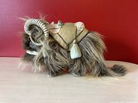 Side view of 1998 Bantha Star Wars action figure showing long fur, curled horns, and saddle detail.